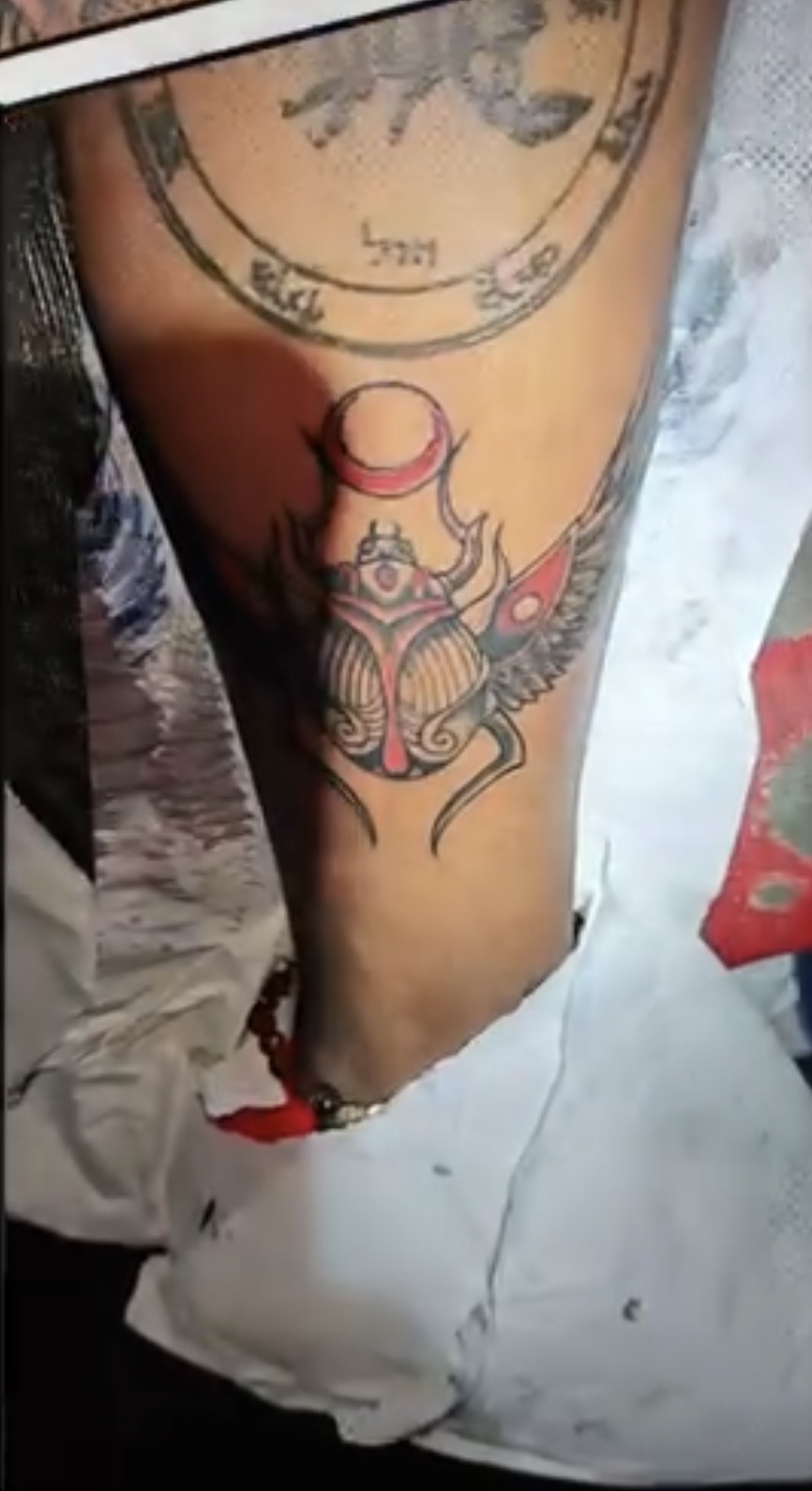 Original winged scarab and crescent tattoo designed by Ainjel on a client’s arm